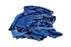 pile-of-blue-denim-jeans-in-a-mess-isolated-on-white-bckground-photo
